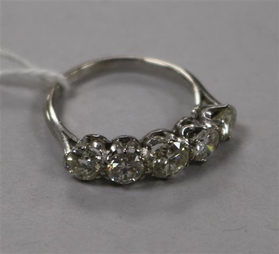 A mid 20th century platinum? and graduated five stone diamond ring, size M.